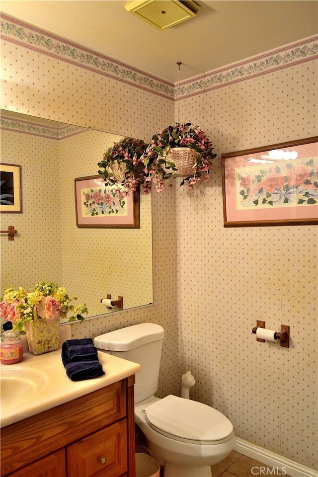 bathroom featuring tile patterned floors, vanity, and toilet