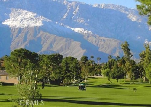 view of home's community with a mountain view and a lawn