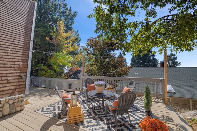 wooden deck featuring an outdoor fire pit