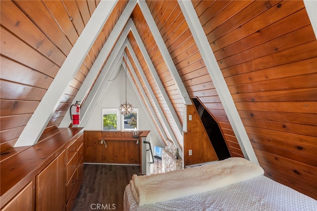 unfurnished bedroom featuring vaulted ceiling with beams, wood walls, dark hardwood / wood-style flooring, and wooden ceiling