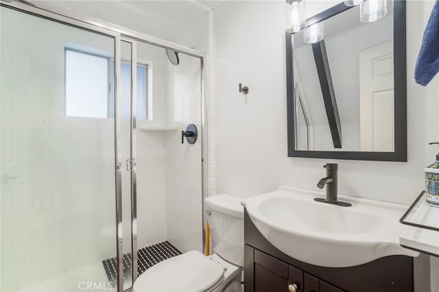 bathroom featuring vanity, toilet, and an enclosed shower