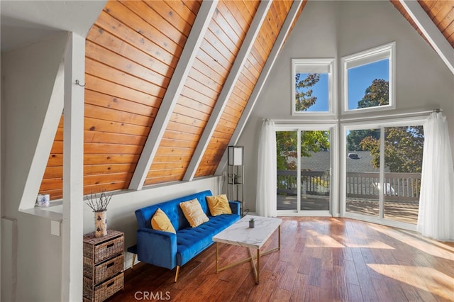 bonus room featuring beam ceiling, hardwood / wood-style floors, high vaulted ceiling, and a wealth of natural light