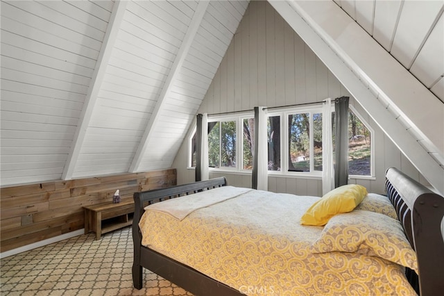 bedroom featuring wood walls and vaulted ceiling