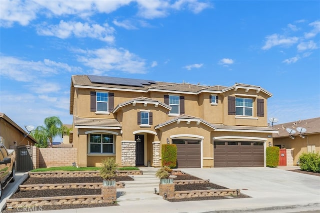 view of front facade with a garage and solar panels