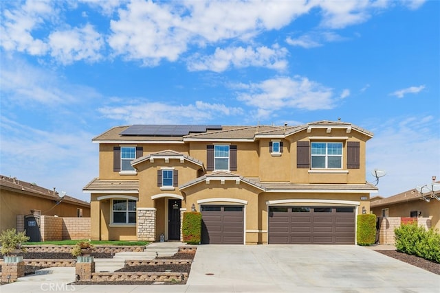 view of front of house featuring a garage and solar panels