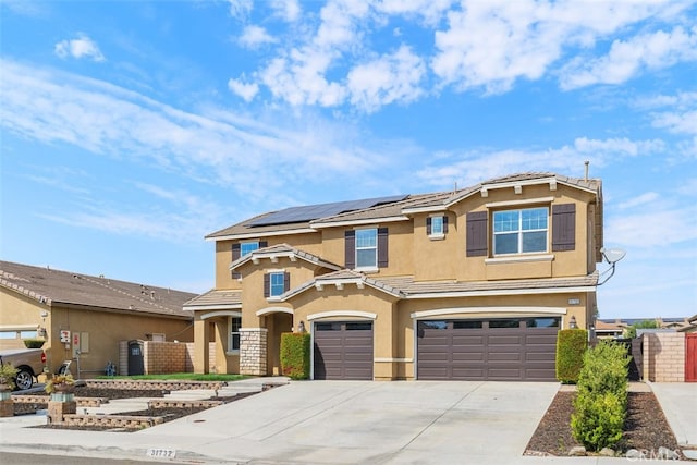 view of front of home with a garage and solar panels