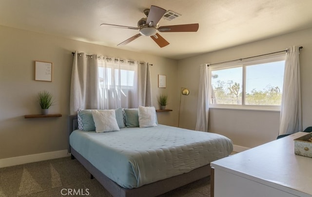 bedroom with ceiling fan, carpet floors, and multiple windows