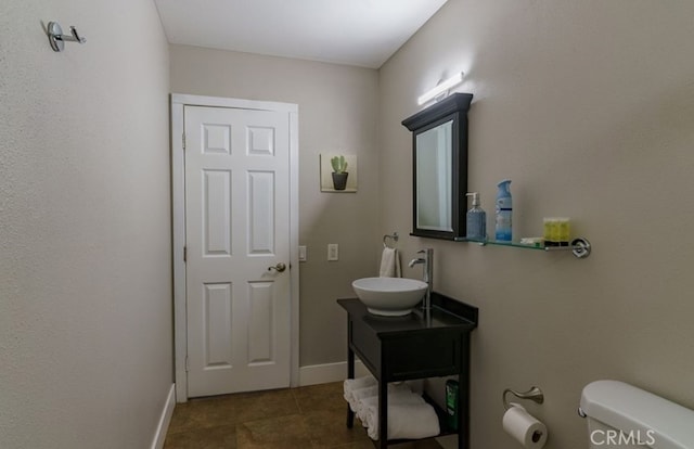 bathroom with vanity, toilet, and tile patterned floors