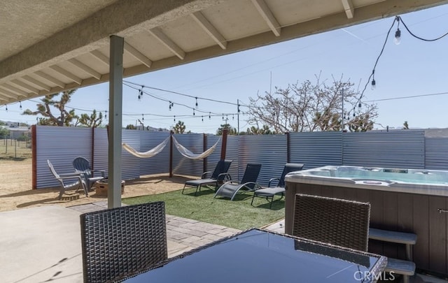 view of patio / terrace featuring a hot tub