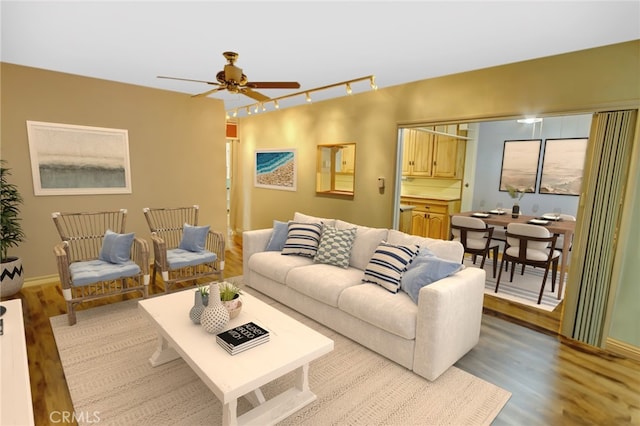 living room featuring ceiling fan and light hardwood / wood-style flooring