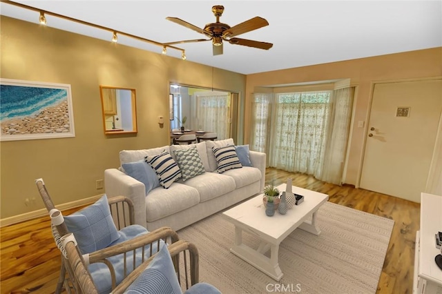 living room featuring ceiling fan, track lighting, and light hardwood / wood-style floors