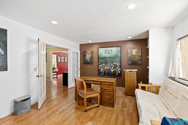 home office featuring light hardwood / wood-style floors and french doors