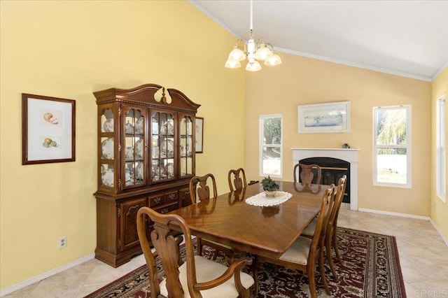 dining room featuring an inviting chandelier, crown molding, vaulted ceiling, and a wealth of natural light