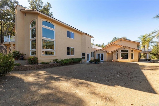 back of house with a balcony