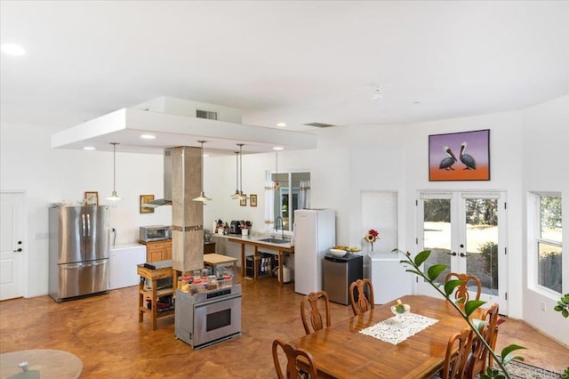 dining area featuring french doors and sink