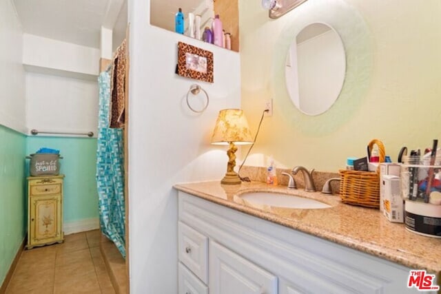 bathroom featuring tile patterned flooring and vanity