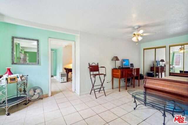 misc room with ceiling fan and light tile patterned flooring