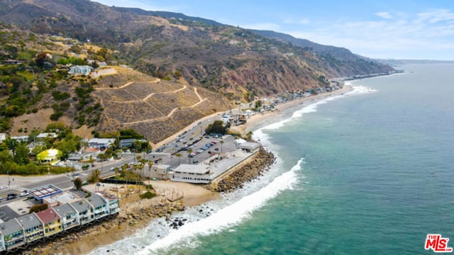 aerial view featuring a water and mountain view