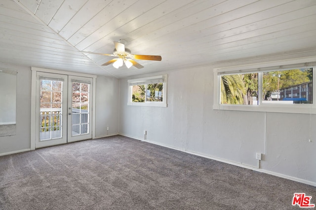 carpeted spare room featuring wood ceiling, lofted ceiling, ceiling fan, and french doors