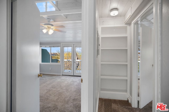 interior space with vaulted ceiling, wood ceiling, built in features, and carpet flooring