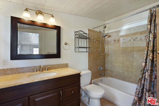 full bathroom featuring shower / bath combination with curtain, vanity, tile patterned flooring, and toilet