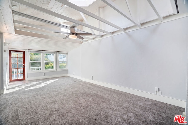 interior space featuring ceiling fan, carpet floors, and lofted ceiling with skylight