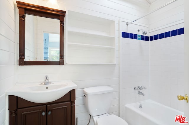 full bathroom featuring tiled shower / bath combo, vanity, and toilet