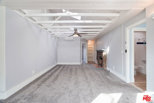 unfurnished living room featuring carpet floors, beam ceiling, an AC wall unit, and ceiling fan