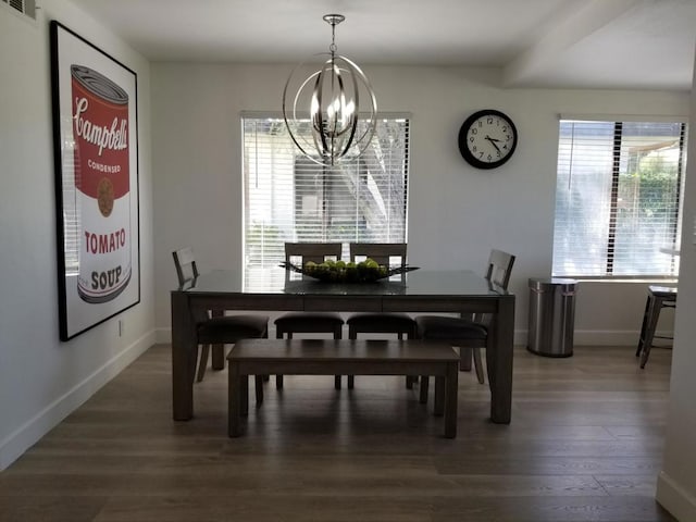 dining room featuring a notable chandelier and dark hardwood / wood-style floors