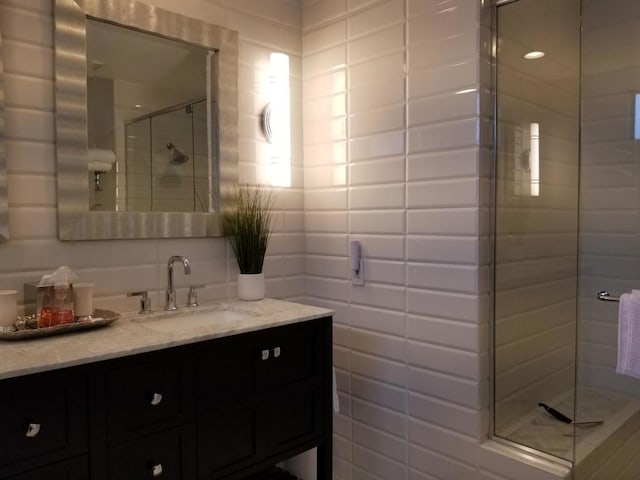 bathroom featuring walk in shower and vanity