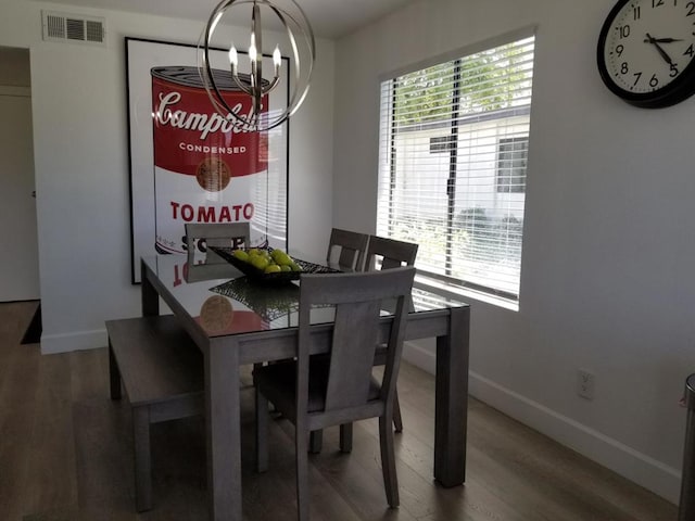 dining area featuring a chandelier and hardwood / wood-style floors