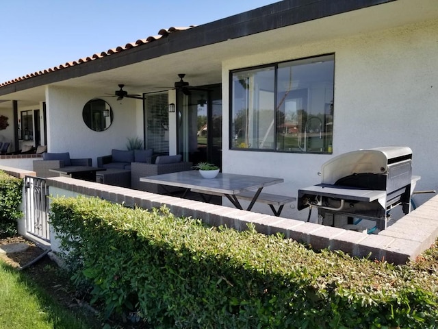 rear view of house featuring outdoor lounge area, a patio, and ceiling fan