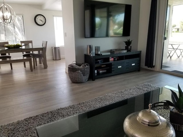 living room with hardwood / wood-style floors and a chandelier