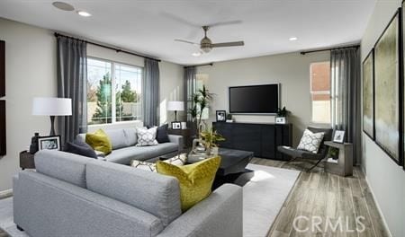 living room featuring ceiling fan and light wood-type flooring