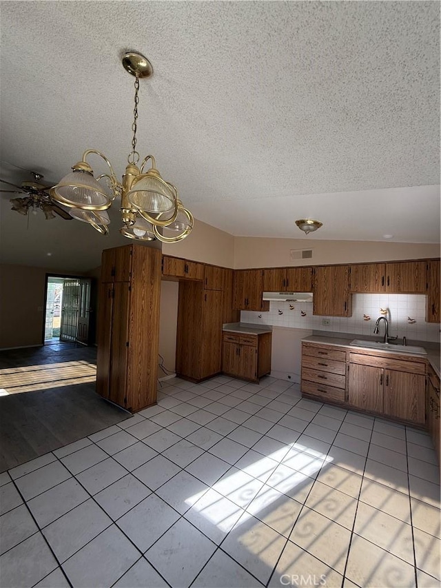 kitchen featuring light tile patterned flooring, sink, ceiling fan, and a textured ceiling