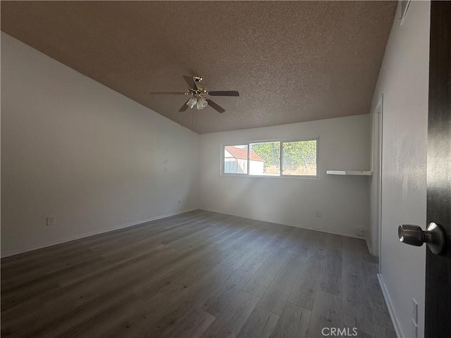 unfurnished room with lofted ceiling, ceiling fan, hardwood / wood-style flooring, and a textured ceiling