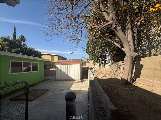 view of patio with a storage shed