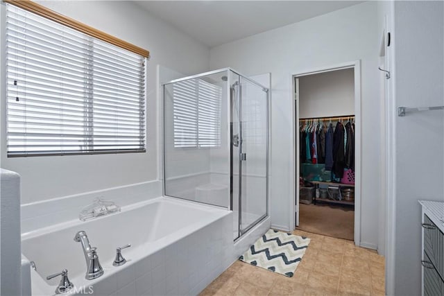 bathroom featuring tile patterned floors and shower with separate bathtub