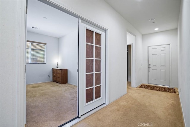 hallway featuring light carpet