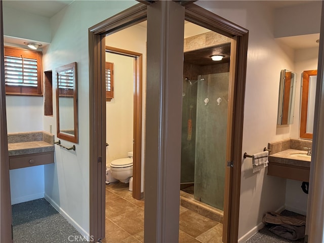 bathroom with walk in shower, vanity, and toilet