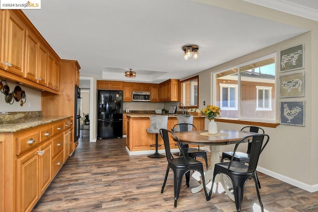 dining space with dark hardwood / wood-style flooring