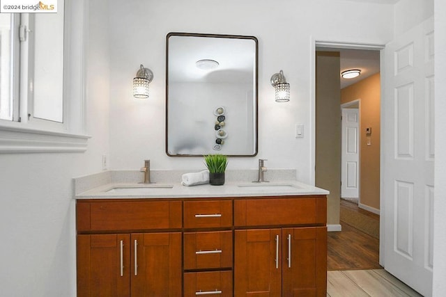 bathroom with vanity and hardwood / wood-style flooring