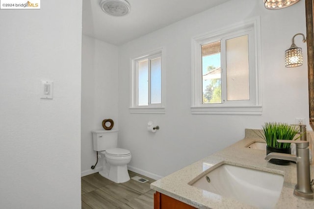 bathroom featuring vanity and toilet