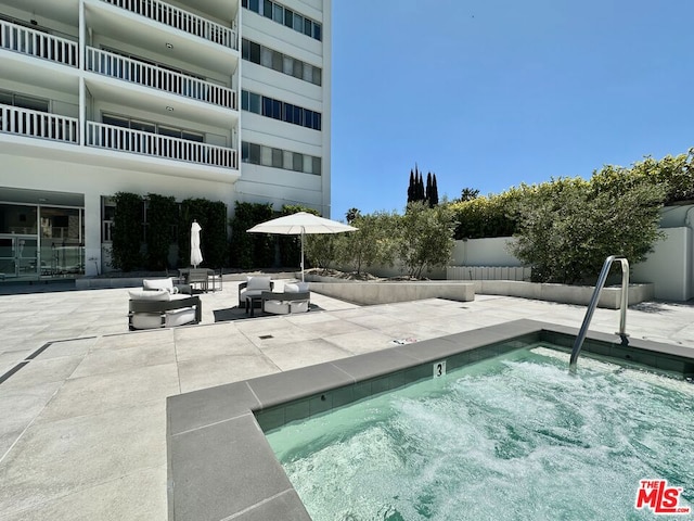 view of pool featuring a patio area and a community hot tub