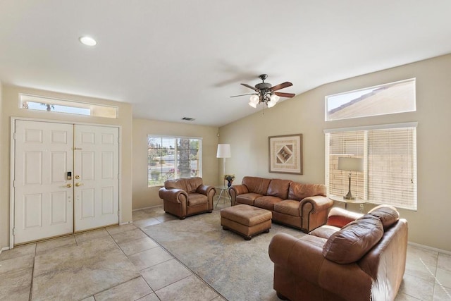 tiled living room with ceiling fan and lofted ceiling