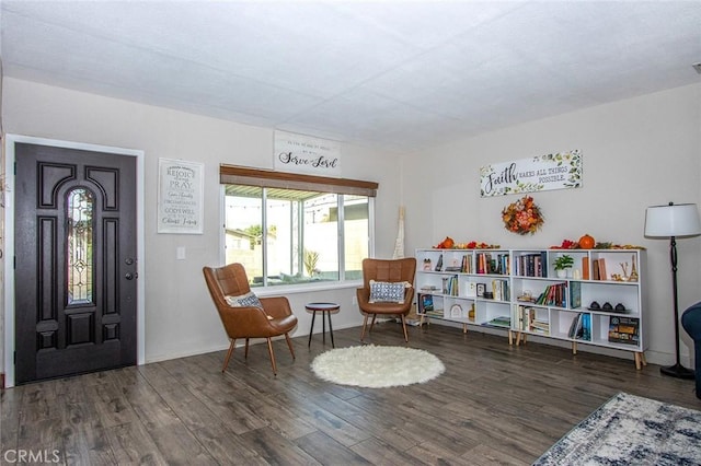 sitting room with dark wood-type flooring