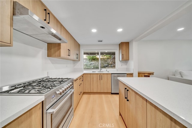 kitchen featuring light brown cabinets, appliances with stainless steel finishes, sink, and light hardwood / wood-style flooring