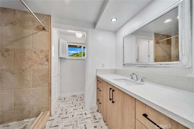 bathroom featuring vanity and tiled shower