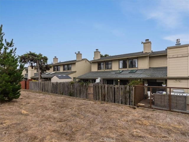 back of property featuring fence