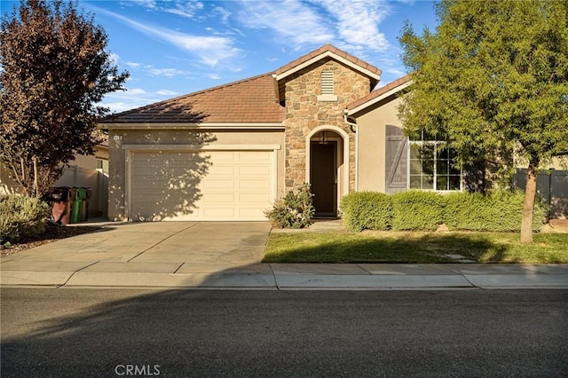 view of front of property featuring a tile roof, stucco siding, a garage, stone siding, and driveway